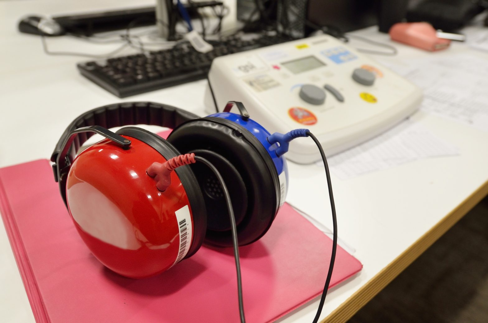 Hearing screening and testing check equipment in a sound-proof testing booth.