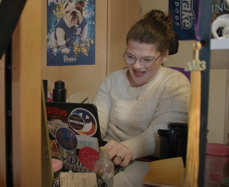 Caroline working in her dorm room at a computer