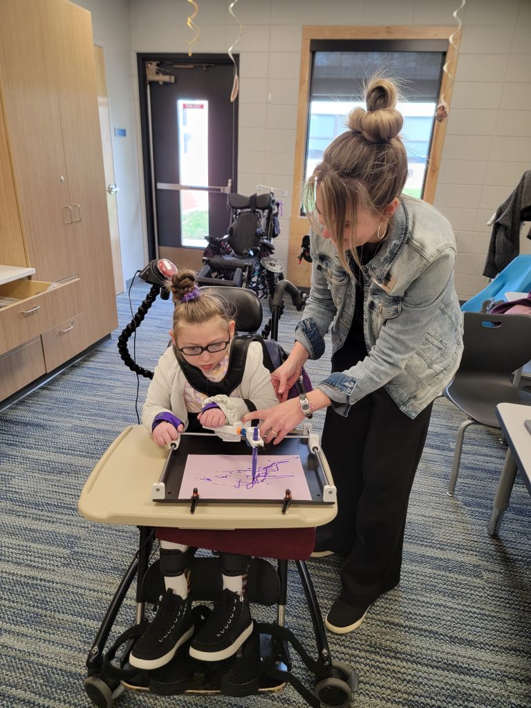 McKenna draws with guided hands during art and journaling to express her ideas.