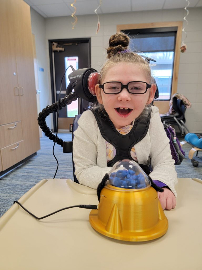 McKenna uses special head switches to make choices, play games and talk with friends.