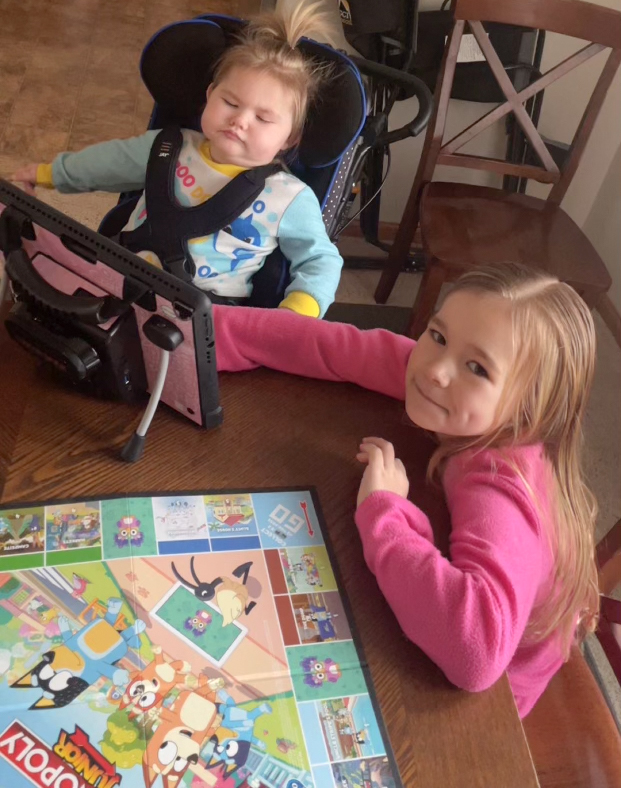 Kori playing a board game with her sister.