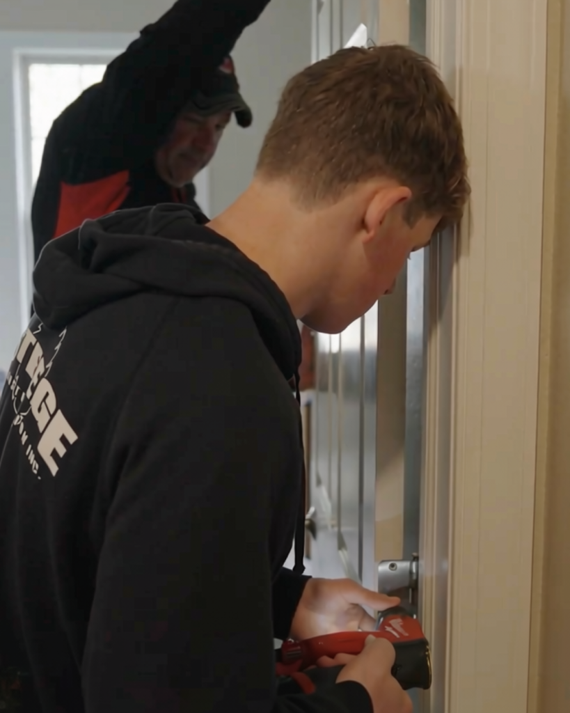 Taylor drilling a screw into a door hinge.